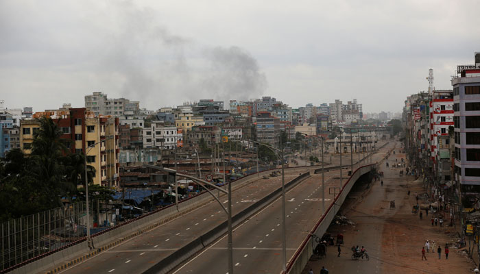 Smoke rises as clashes continue at the Shonir Akhra area after violence erupts following protests by students against government job quotas, in Dhaka, Bangladesh, July 21, 2024.