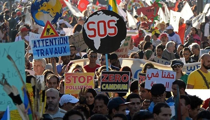 Moroccan and international demonstrators shout slogans and hold placards during a demonstration against climate change and calling for environmental action to protect the planet during a protest in Marrakesh. — AFP/File