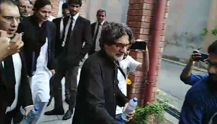 PTI Information Secretary Raoof Hasan walks as he is presented before a court for a hearing in Islamabad on July 23, 2024. — Geo News