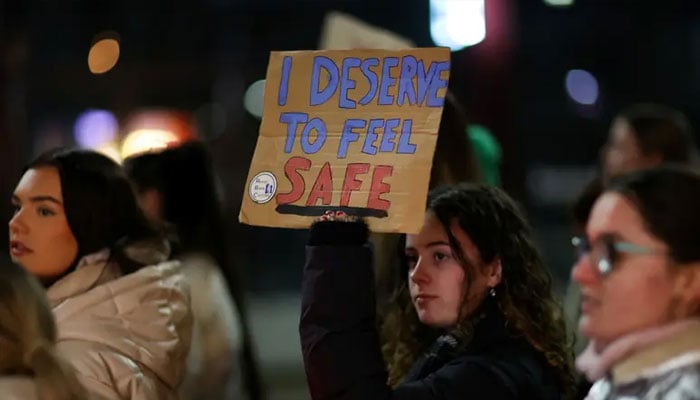 A woman holds a placard as people gather to demonstrate during the Reclaim the Night march to stop gender based violence, in Manchester, Britain, November 29, 2023. — Reuters