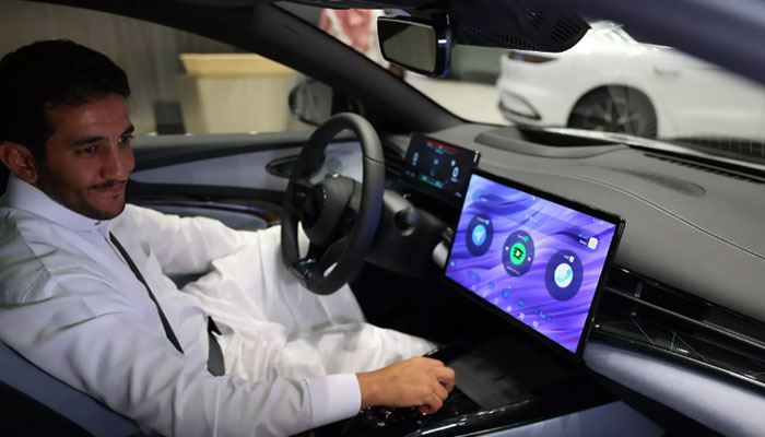 A person sitting on the driving seat of an EV car in Saudi Arabia. — AFP/File