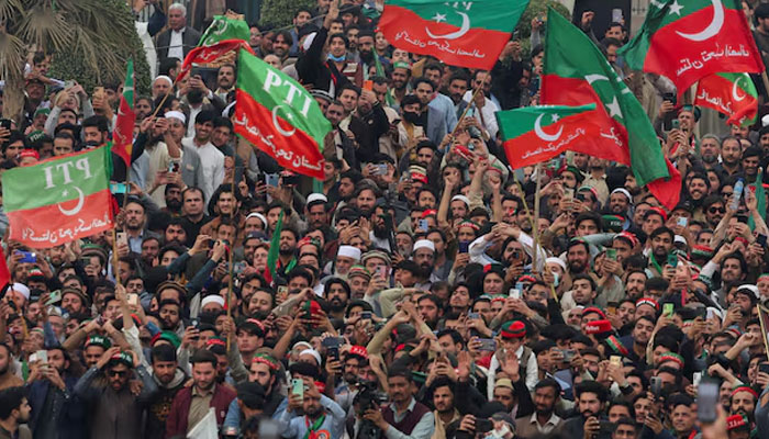 Supporters of former Prime Minister Imran Khans party, the Pakistan Tehreek-e-Insaf (PTI), wave flags as they protest demanding free and fair results of the elections, in Peshawar, Pakistan February 17, 2024. — Reuters