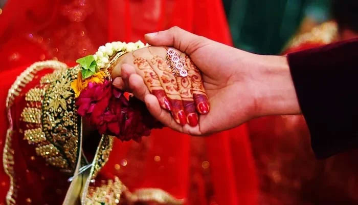 A bride and groom holding hands in what seems to be a wedding ceremony. — Unsplash