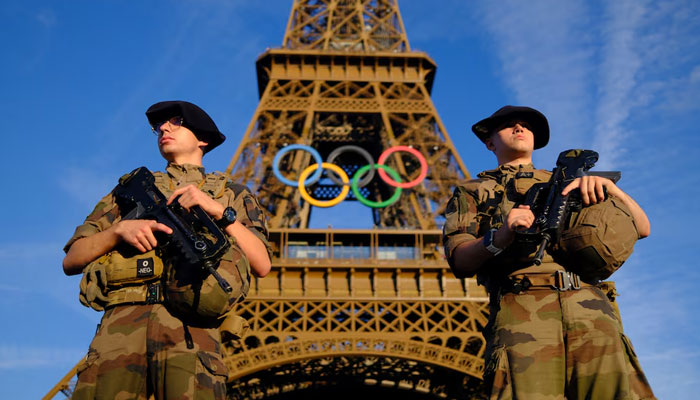 Soldiers patrol on a street in front of the Eiffel Tower ahead of the Olympics in Paris, France on July 21, 2024. — Reuters