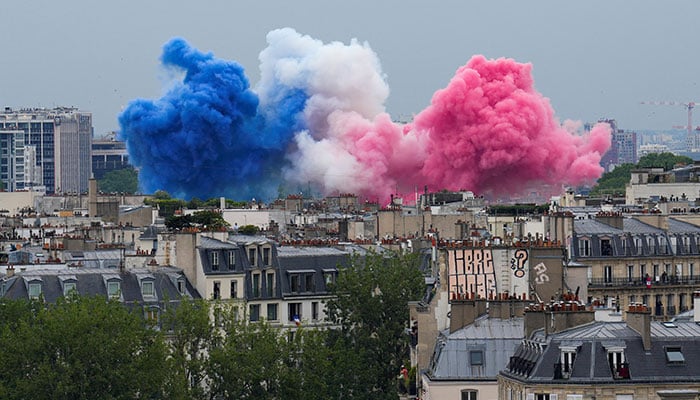 Smoke in the colours of the France flag are set off in Paris, France, at the start of the opening ceremony for the 2024 Summer Olympics. — Reuters