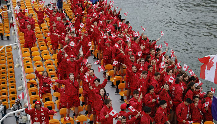 Team Canada aboard a boat in the floating parade on the river Seine during the opening ceremony. — Reuters