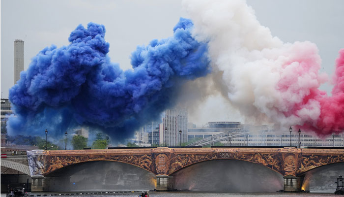 A giant plume of blue, white, and red smoke in the opening ceremony. — Reuters