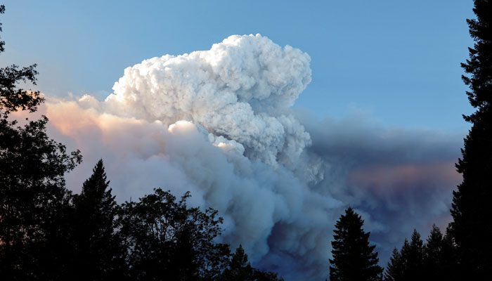 A smoke plume rises from the Park Fire, along Highway 32 near Butte Meadows, California, US on July 26, 2024. — Reuters