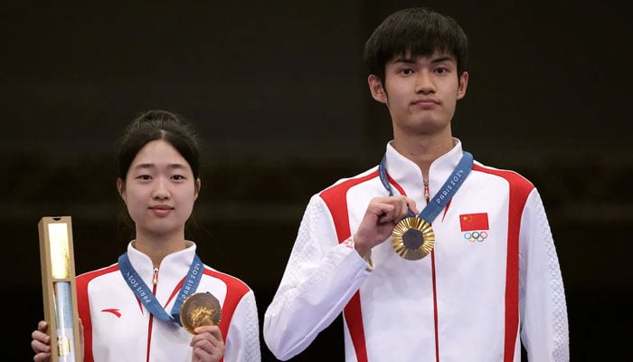 Yuting Huang of China (left) and Lihao Sheng of China posing with their gold medals at the Paris Olympics, Paris, France on July 27, 2024. — Reuters