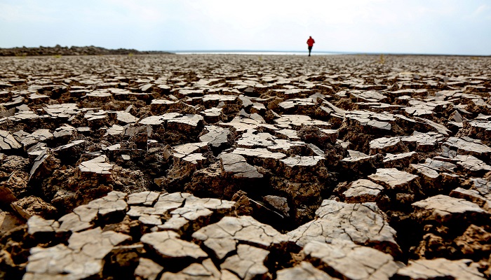 A person walks along cracks at the partly dried up Devegecidi Dam, northwest of drought-stricken Diyarbakir, Turkey October 29, 2021. Picture taken October 29, 2021.— Reuters