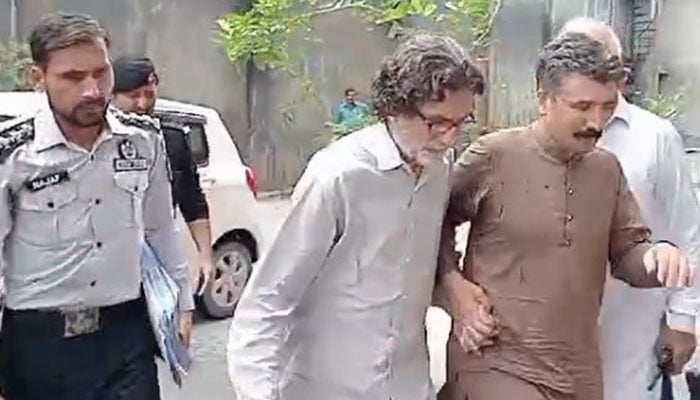 PTI Information Secretary Raoof Hasan walks as he is presented before a court for a hearing in Islamabad on July 28, 2024. — Geo News