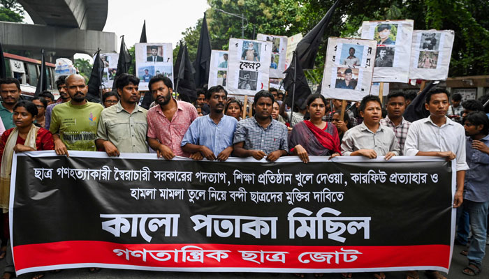 People take part in a protest march against the mass arrest and killing of protesters during last week´s violence amid anti-qouta protests, in Dhaka on July 28, 2024. — AFP