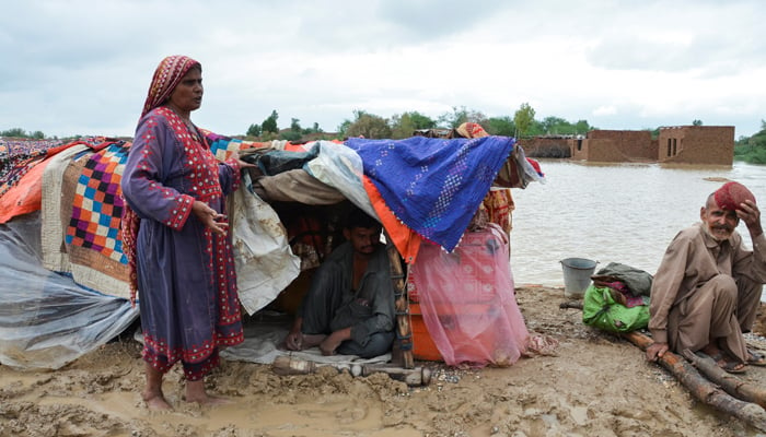 A family takes refuge on a higher ground following rains and floods during the monsoon season in Dera Allah Yar, district Jafferabad, Balochistan, on August 25, 2022. — Reuters