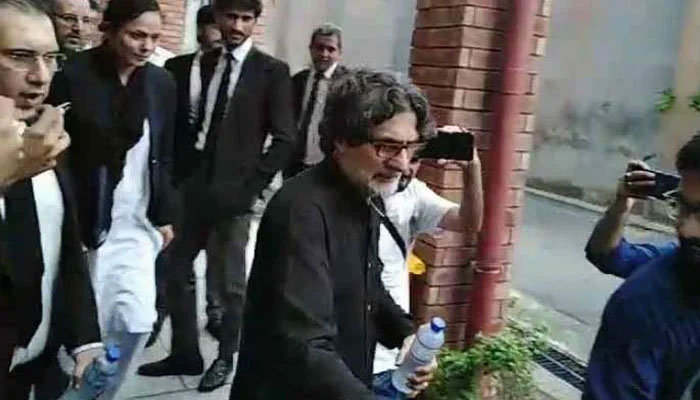 PTI Information Secretary Raoof Hasan walks as he is presented before a court for a hearing in Islamabad on July 23, 2024. — YouTube/Geo News/Screengrab