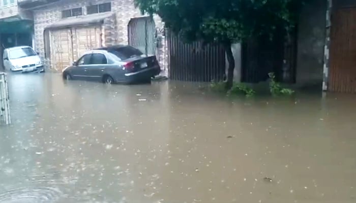 Cars can be seen in a pool of water after torrential rains hit Lahore, on August 1, 2024. — Reporter