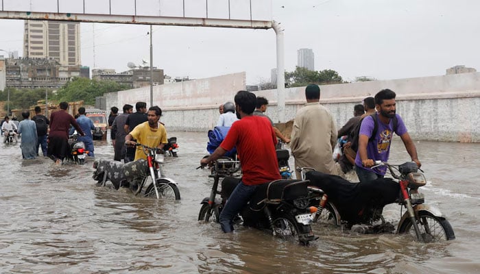 Residents commute through a flooded road during the monsoon season in Karachi, Pakistan July 9, 2022. — Reuters