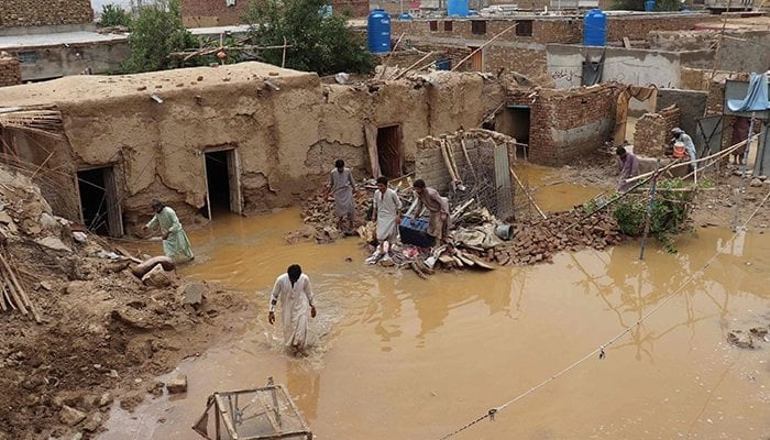 Residents clear debris of a damaged house due to a heavy monsoon rainfall on the outskirts of Quetta on July 5, 2022. — AFP