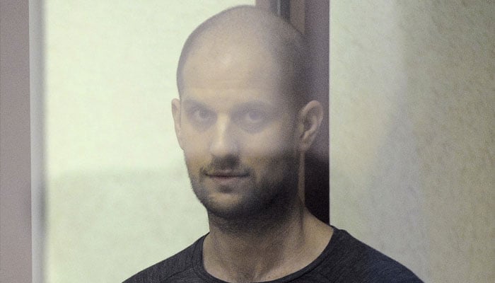 Wall Street Journal reporter Evan Gershkovich, who faces charges of espionage, stands inside an enclosure for defendants as he attends a court hearing in Yekaterinburg, Russia July 19, 2024. — Reuters