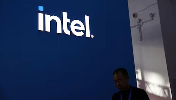 A man walks past the Intel logo at its booth during the first China International Supply Chain Expo (CISCE) in Beijing, China November 28, 2023. — Reuters