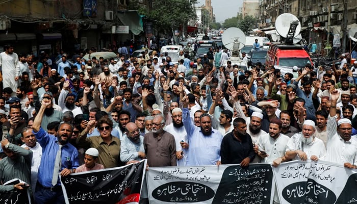 People chant slogans against the hikes in fuel prices and power billings, during a protest in Karachi. — Reuters/File