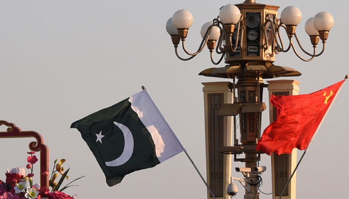 Pakistani and Chinese national flags flutter next to an installation featuring a giant flower basket at Tiananmen Square in Beijing, China October 7, 2019. — Reuters