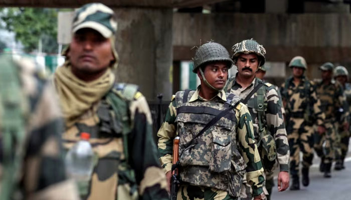 Indian security forces personnel patrol a deserted street. — Reuters/File