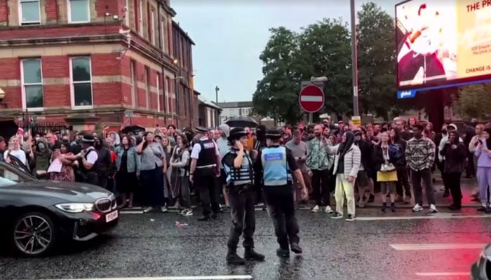 People protesting outside Abdullah Quilliam mosque in Liverpool. — Reuters