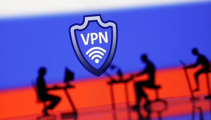 A VPN sign is seen in front of silhouetted miniatures of people with computers and the Russian flag in this illustration taken, April 23, 2024. — Reuters