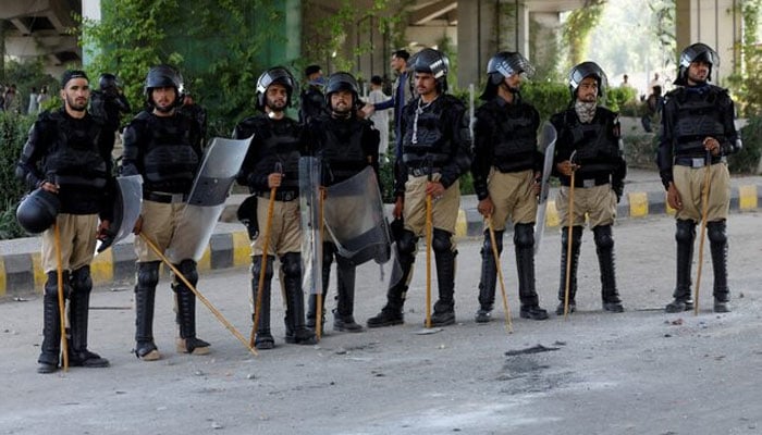 Police personnel in riot gear stand guard outside a Radio Pakistan office building in Peshawar, May 11, 2023. — Reuters