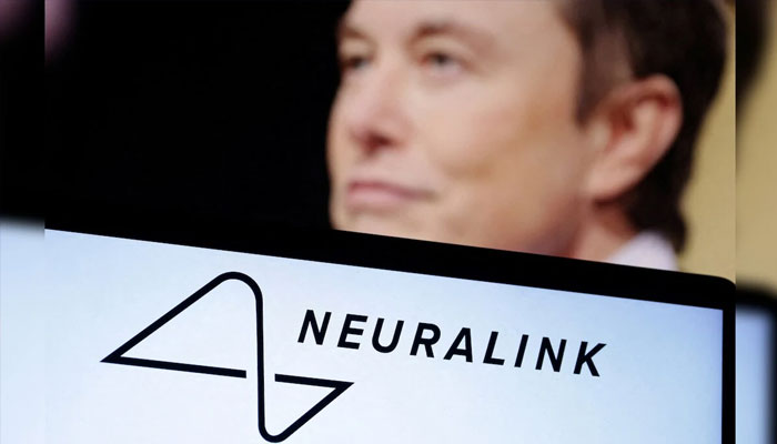 Elon Musk said seen in the background with a Neuralink logo on a screen.— Reuters/file