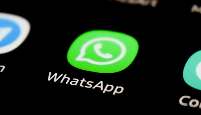 A representational image of the WhatsApp icon displayed on a phone screen. — Unsplash