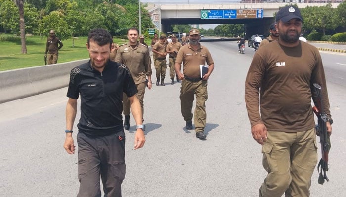 German tourist Berg Florian walking with police officials. — Reporter