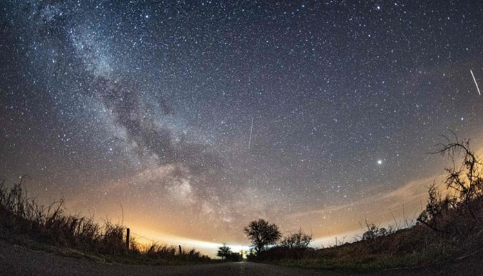 The Milky Way and the meteors of the April Lyrids meteor shower visible in the night sky over Burg auf Fehmarn on the Baltic Sea Island of Fehmarn, northern Germany. — AFP/File