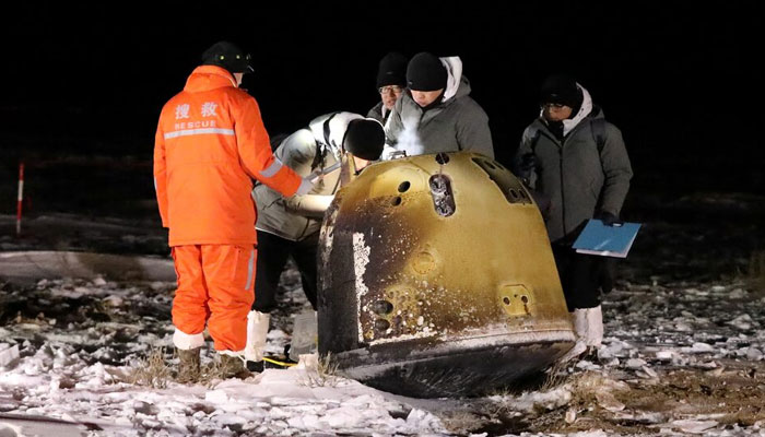 Researchers work next to Change-5 lunar return capsule carrying moon samples, after it landed in northern Chinas Inner Mongolia Autonomous Region, December 17, 2020. — Reuters