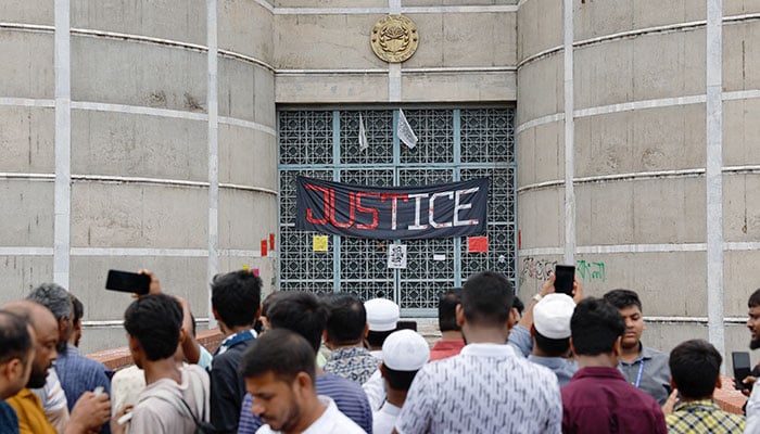 People gather at the entrance of the parliament building a day after the resignation of ousted Bangladeshi PM Sheikh Hasina, in Dhaka, Bangladesh, August 6, 2024. — Reuters