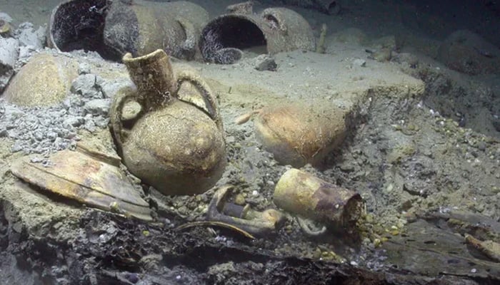 Remains of the cargo comprising pots, pans and other metal items made in Algiers carried by the pirate ship to masquerade as a trading vessel, seen on the wrecks present deep in the sea. — Seascape Artifact Exhibits Inc.