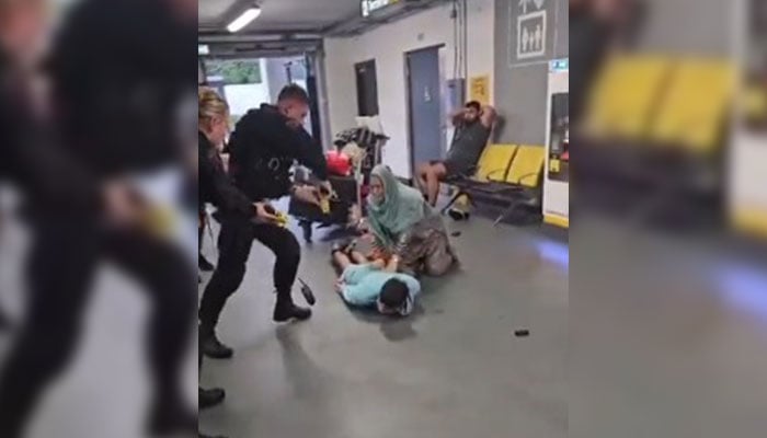 Police officers take down a young man at the Manchester Airport. — Screengrab via X/@MurtazaViews/File