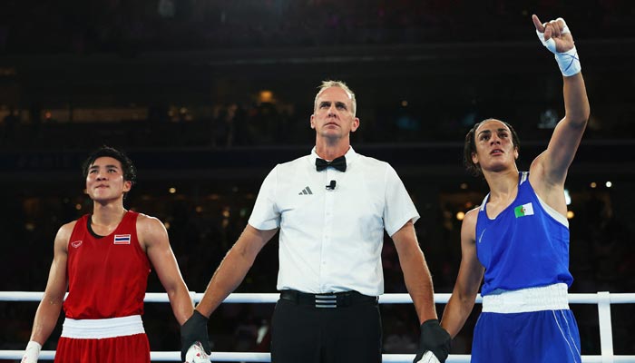 Imane Khelif of Algeria raises her hand next to Match Referee Shawn Reese after winning her fight against Janjaem Suwannapheng of Thailand on August 6, 2024. — Reuters