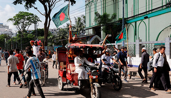 People waves Bangladeshi flag as they celebrate the resignation of Prime Minister Sheikh Hasina in Dhaka, Bangladesh, August 5, 2024. — Reuters