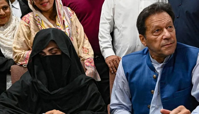 PTI founder Imran Khan (right) and his wife Bushra Bibi. — AFP