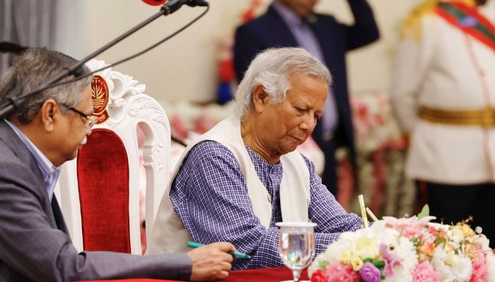 Muhammad Yunus signs the oath book as the country’s head of the interim government in Bangladesh at the Bangabhaban, in Dhaka, Bangladesh on August 8, 2024. — Reuters