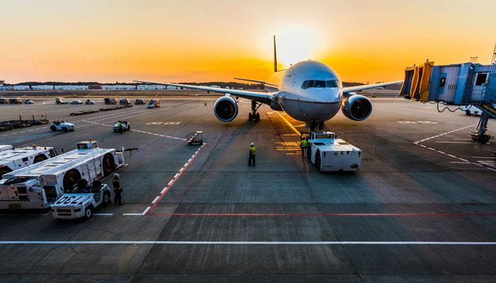 A representational image shows an airplane being towed at an airport. — Unsplash