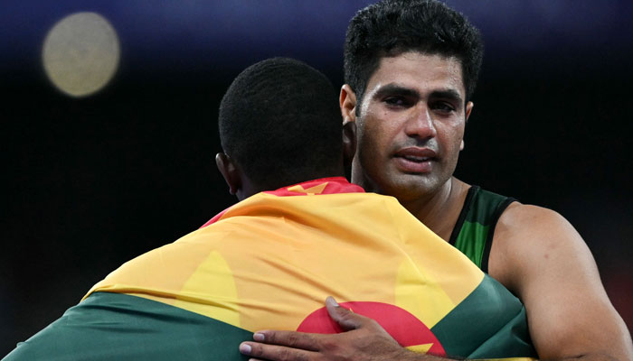 Bronze medallist Grenadas Anderson Peters (front) congratulates Gold medallist Pakistans Arshad Nadeem after competing in the mens javelin throw final of the athletics event at the Paris 2024 Olympic Games at Stade de France in Saint-Denis, north of Paris, on August 8, 2024. — AFP