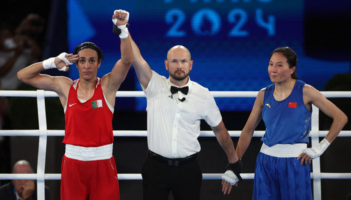 Imane Khelif of Algeria salutes as she celebrates winning against Liu Yang of China on August 9, 2024. — Reuters