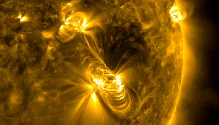 A medium-sized (M2) solar flare and a coronal mass ejection (CME) erupting from the same, large active region of the Sun on July 14, 2017. — Reuters