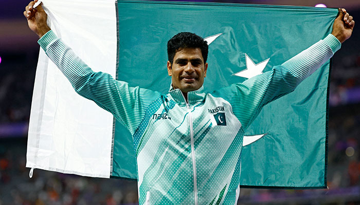 Arshad Nadeem poses with the national flag after winning the gold medal in the Mens Javelin Throw final event in Paris Olympics 2024 at Stade de France, Saint-Denis, France on August 08, 2024. — Reuters