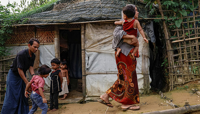 Representational image of a Rohingya family who fled from Buthidaung, Myanmar, to Bangladesh, walk at a refugee camp in Coxs Bazar, Bangladesh, June 25, 2024. — Reuters