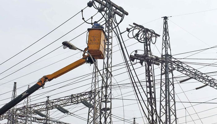 A worker of WAPDA busy is repairing high voltage electric wires at Shadman grid station in Lahore on February 19, 2023. — Online