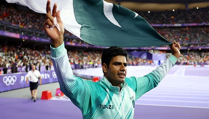 Arshad Nadeem poses with the national flag after winning the gold medal in the Mens Javelin Throw final event in Paris Olympics 2024 at Stade de France, Saint-Denis, France on August 08, 2024. — Reuters