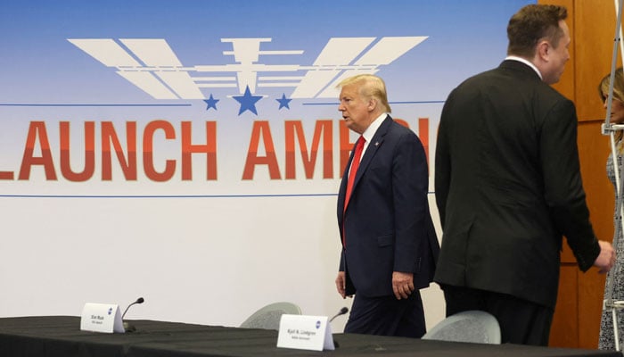 Former US president Donald Trump passes SpaceX founder and CEO Elon Musk as he arrives with first lady Melania Trump to attend a SpaceX mission briefing before watching the planned launch of a SpaceX Falcon 9 rocket carrying two NASA astronauts to the International Space Station at the Kennedy Space Center in Cape Canaveral, Florida, on May 27, 2020. —Reuters/File